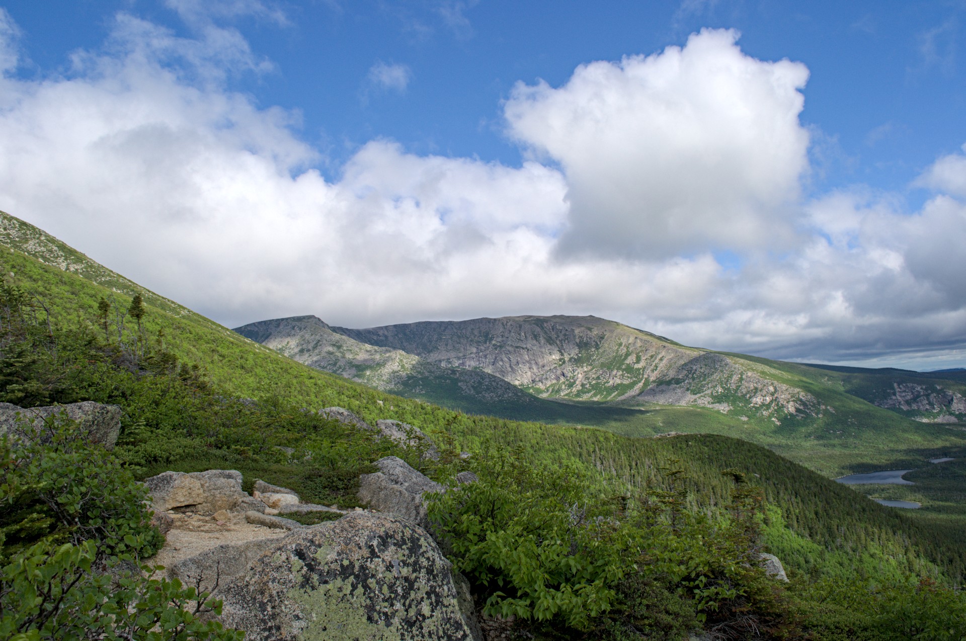 Looking up at the South Basin cirque from the approach — Katahdin's headwall and the green sweep of the basin, Chimney Pond just visible below
