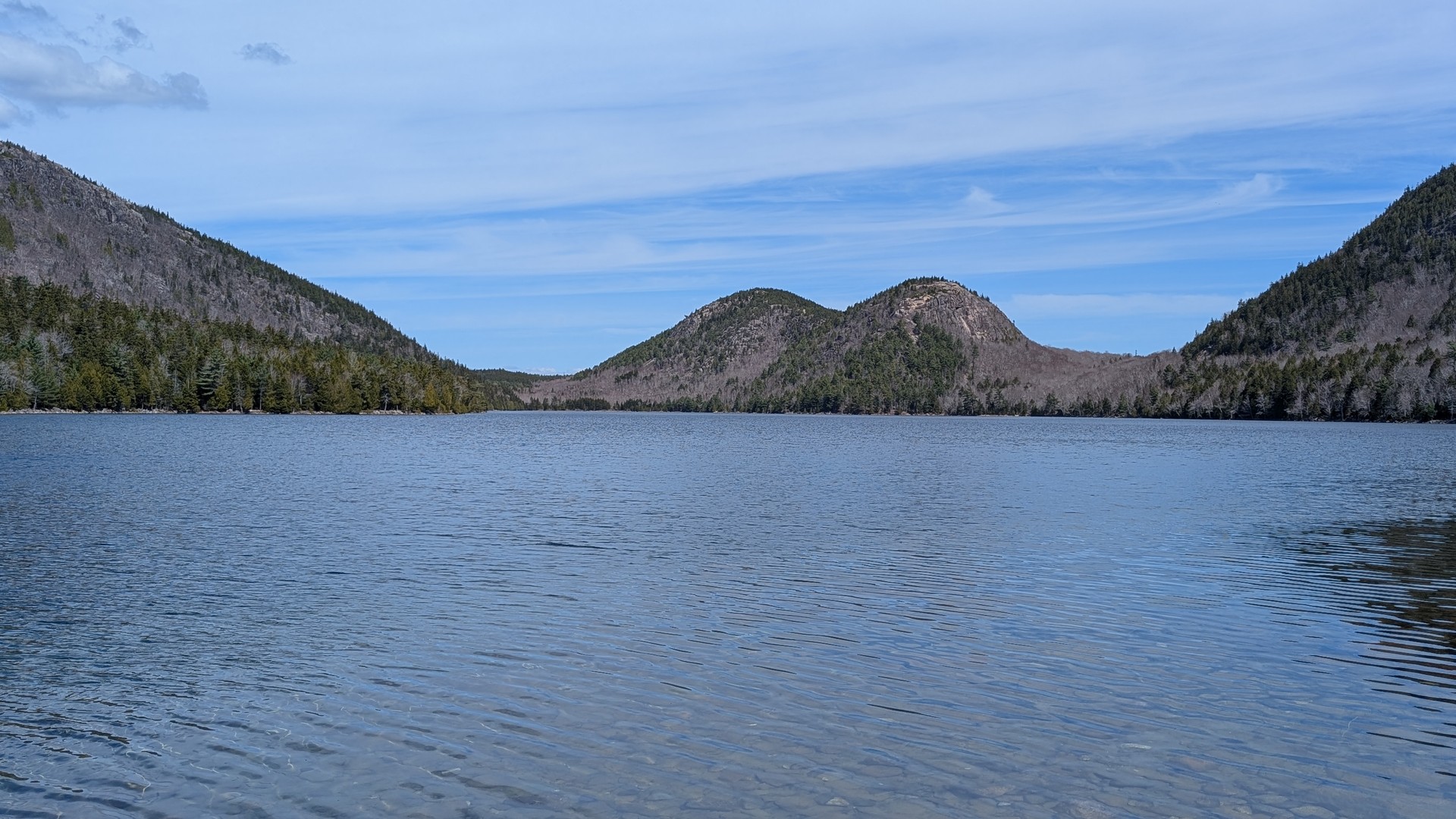 The Bubbles from the first clear viewpoint on the east shore — both domes reflected in the still pond on a calm morning