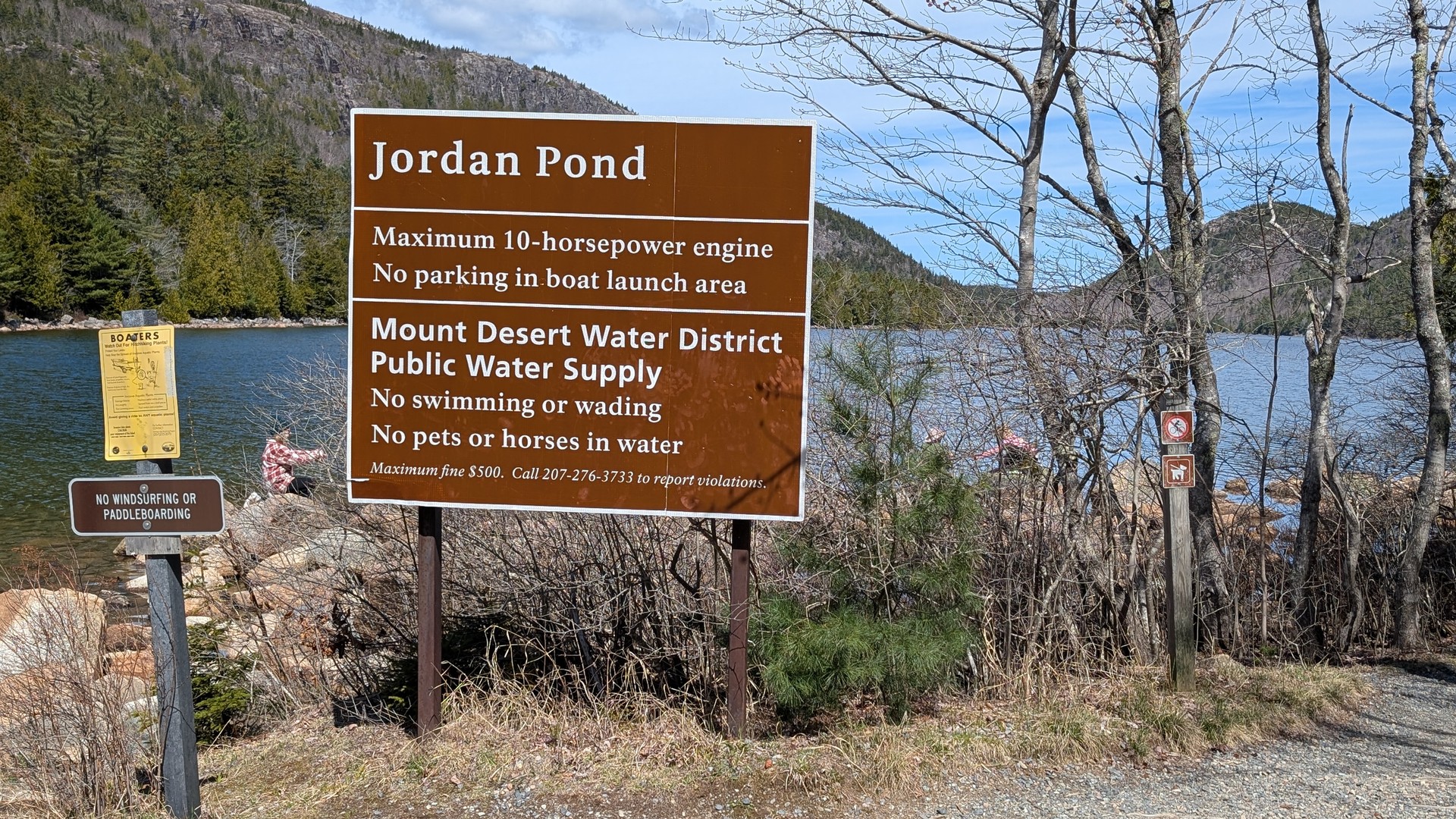 The trailhead path at the start of the Jordan Pond loop — wide gravel, flat, easy footing in late April