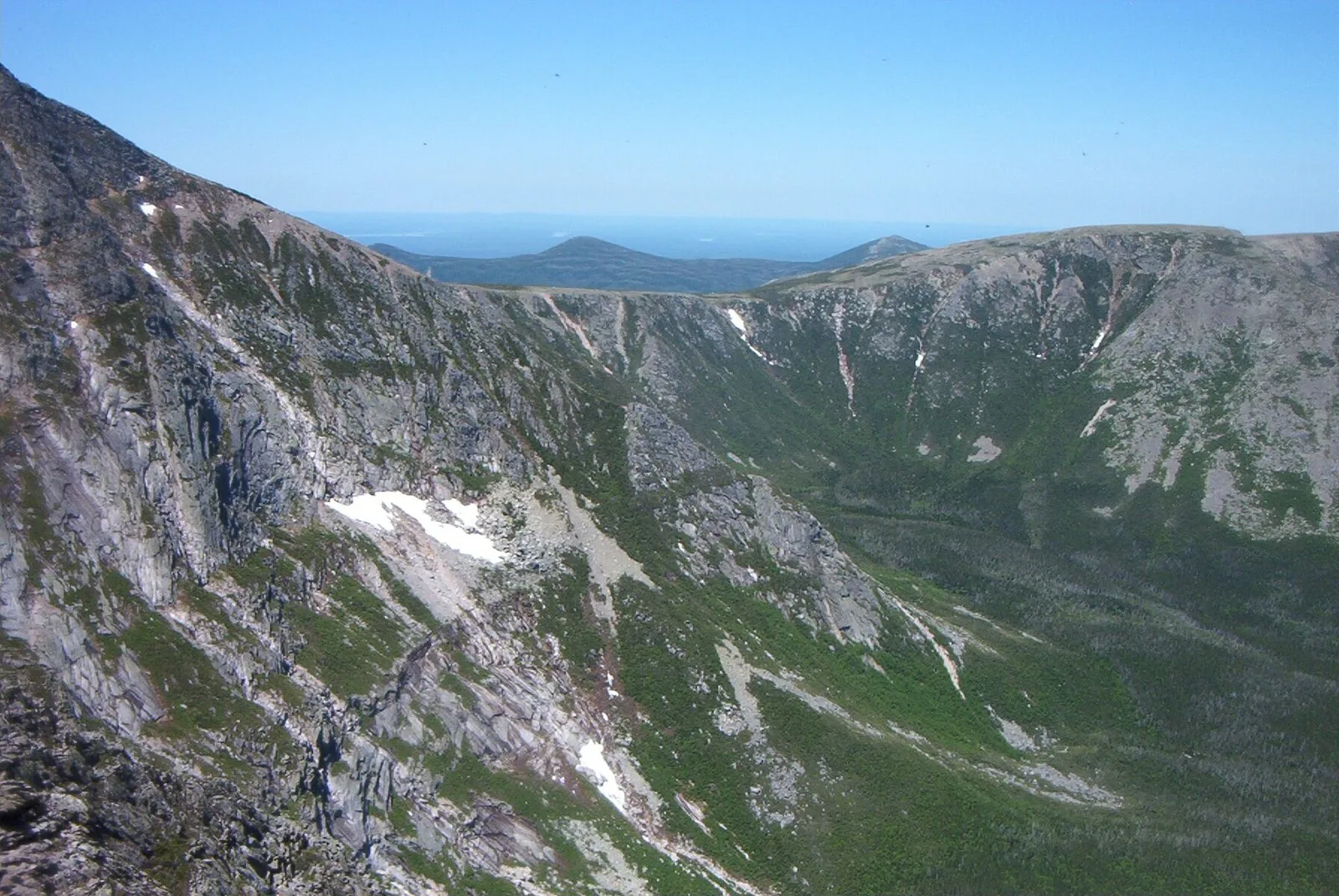 South Basin glacial cirque from the Knife Edge — the full amphitheater with curving headwall cliffs and patches of snow lingering into summer